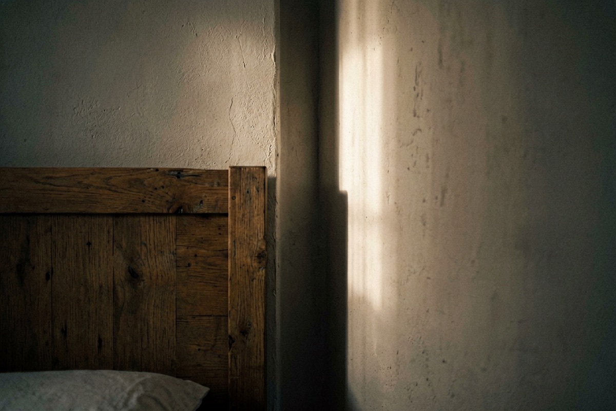 A narrow dark gap between a bed head and the wall behind it (AI-generated illustration)