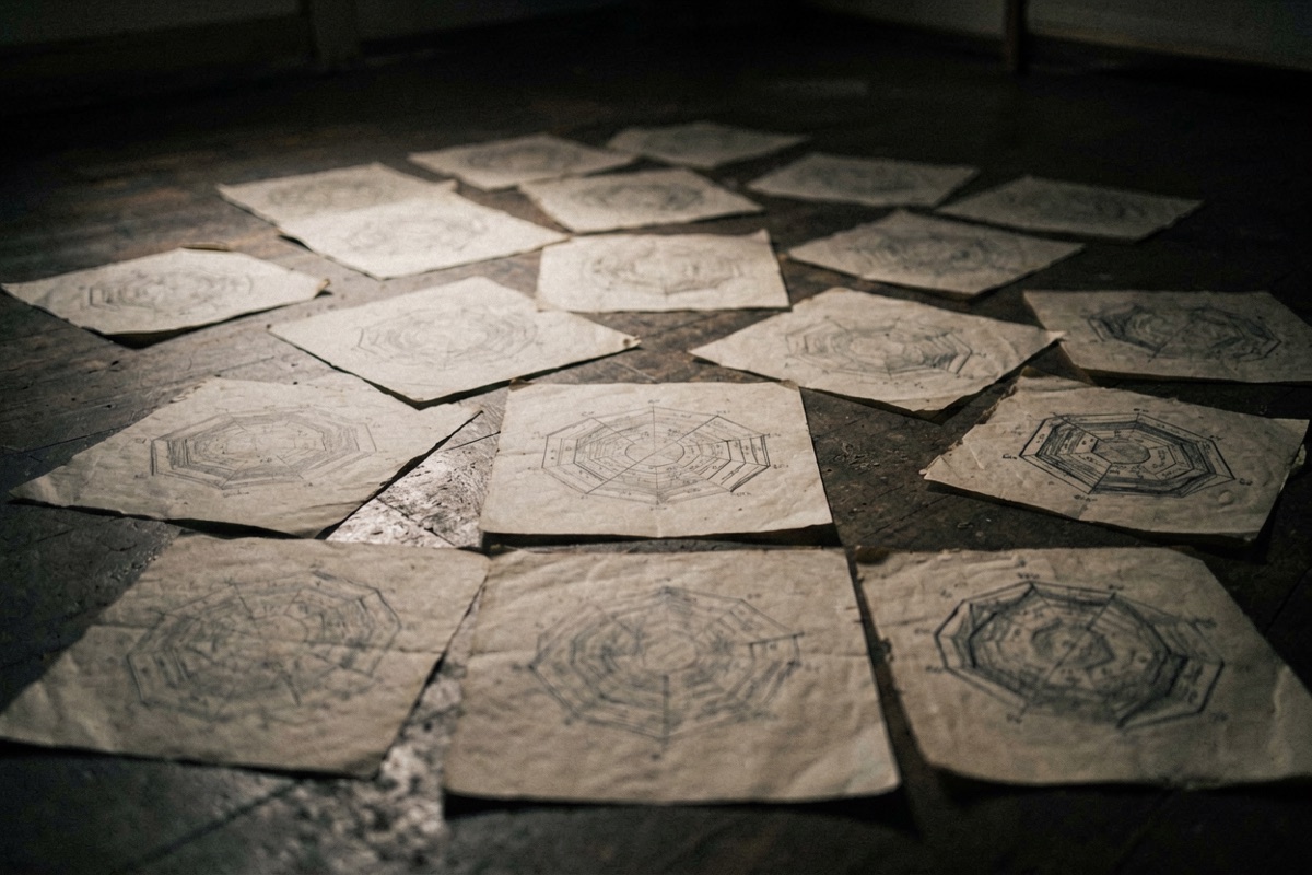 Dozens of hand-drawn hexagram charts spread across a floor (AI-generated illustration)